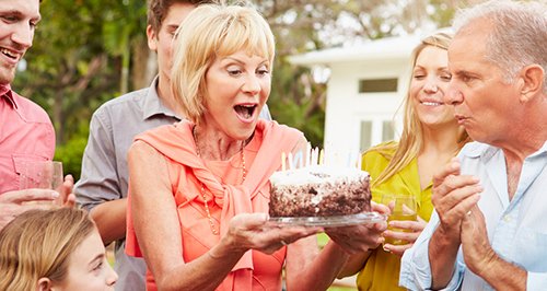 A family celebrating with a birthday cake